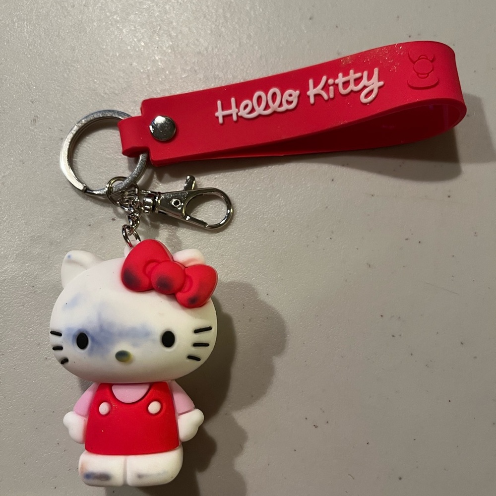 Hello Kitty Red and White Keychain. Stained ink on front and back